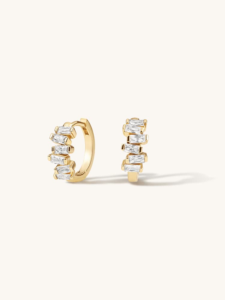 Small gold-tone hoop earrings with pale stones