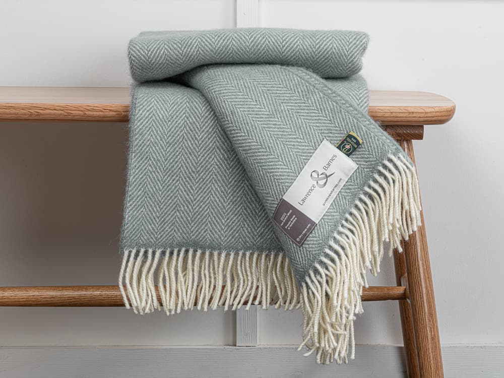 Grey and green throws folded over a chair