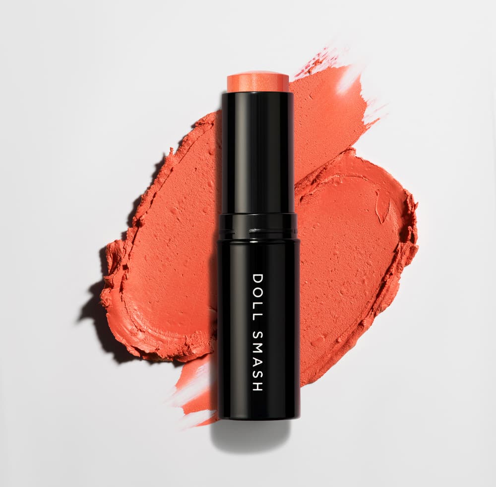 Coral cosmetic product beside a matching texture swatch