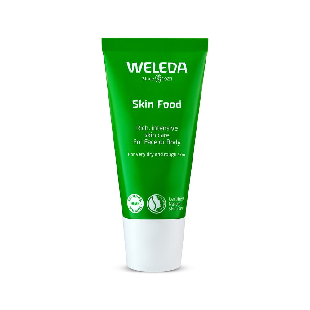 Green skincare tube photographed against white