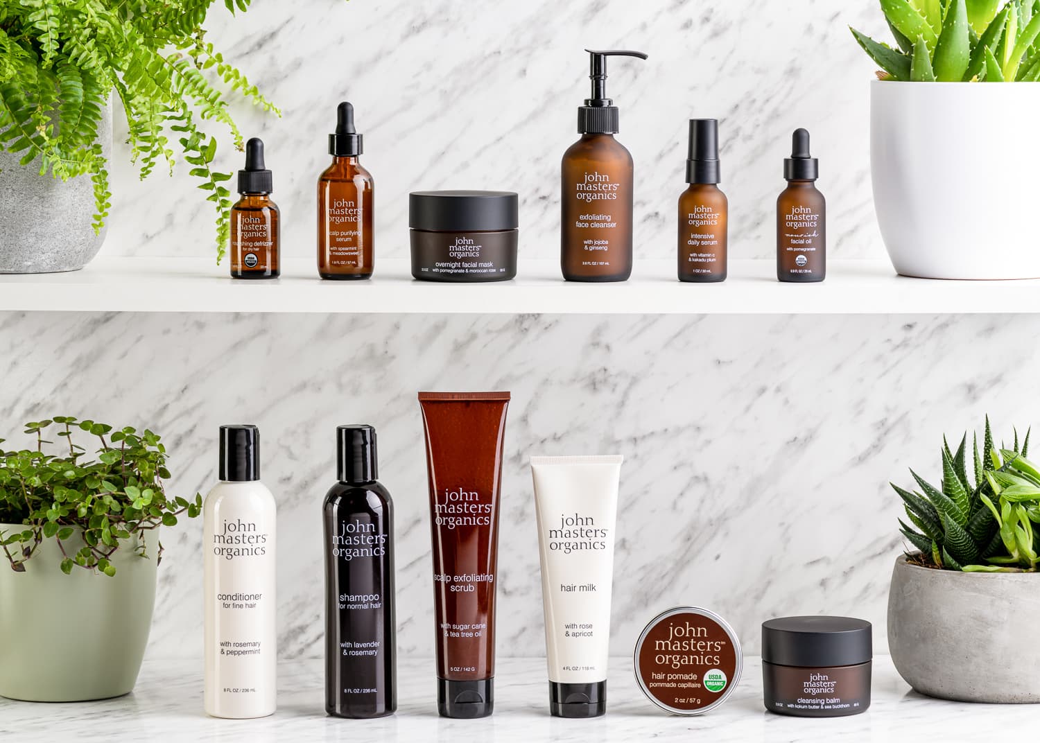 Hair and body products arranged on two bathroom shelves