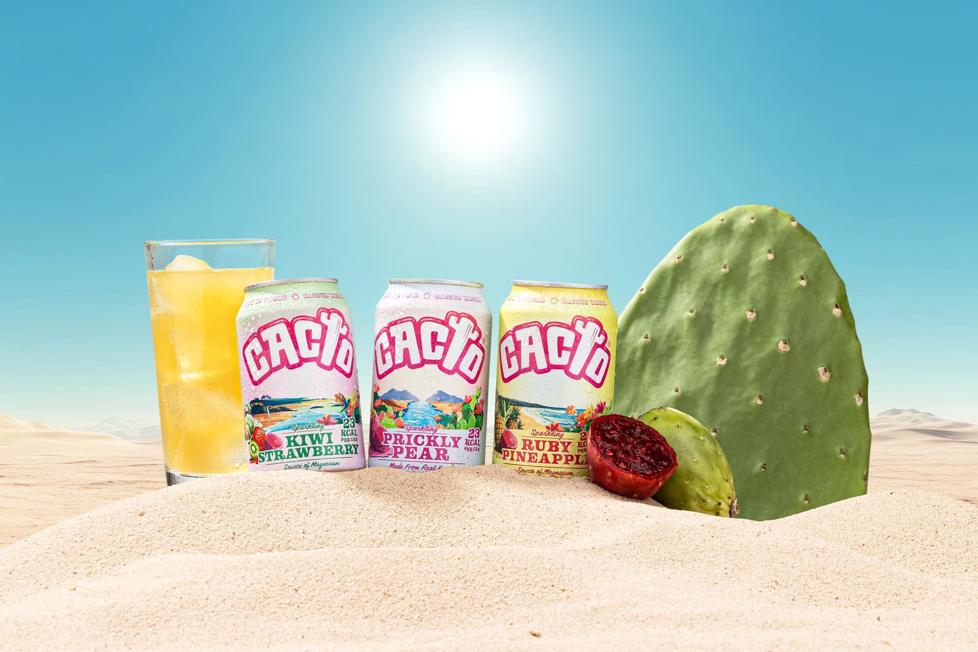 Three colourful drinks cans in a bright desert-style scene