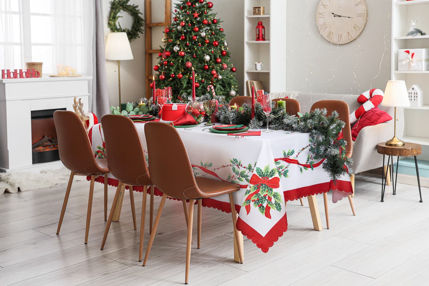 Christmas dining table with red styling and a decorated tree